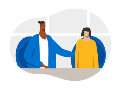 Two people sat together at a table talking to each other